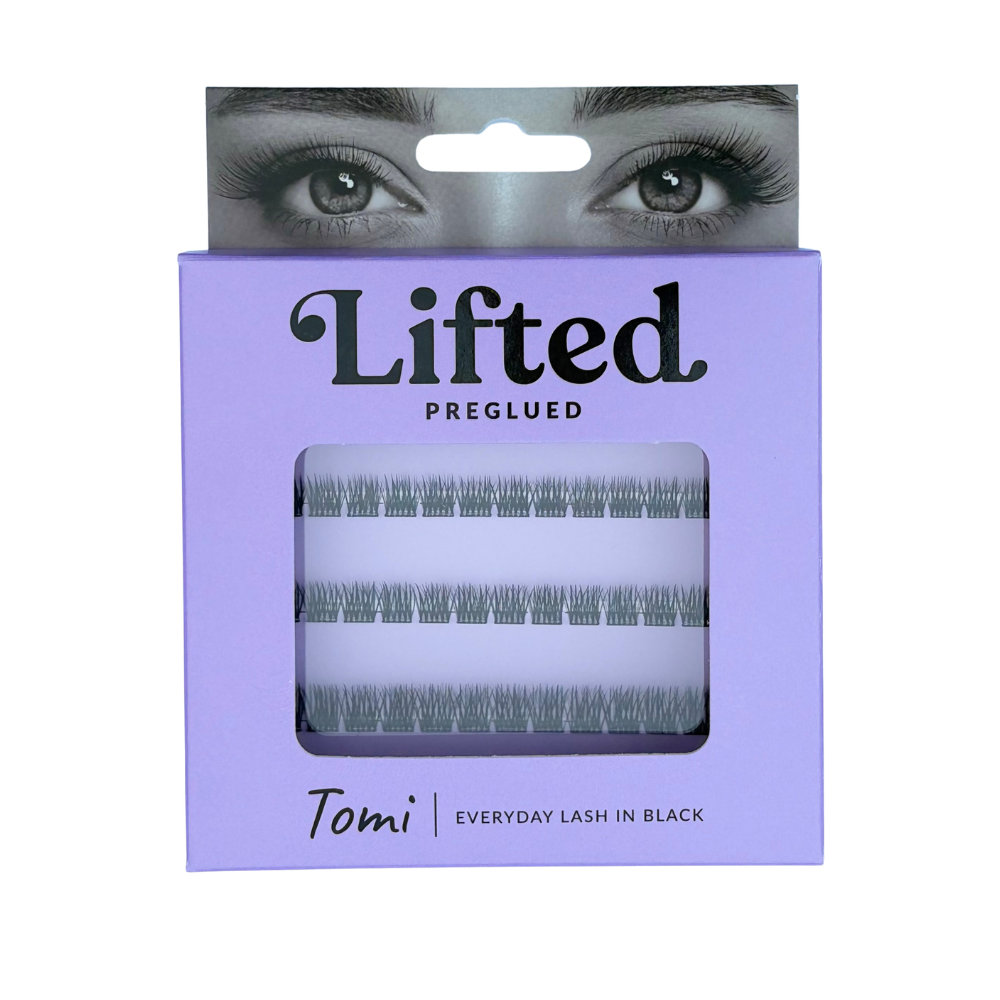 Lifted Tomi preglued eyelash clusters in black, presented in a lavender purple cardboard box with a clear window showing the lash clusters inside.